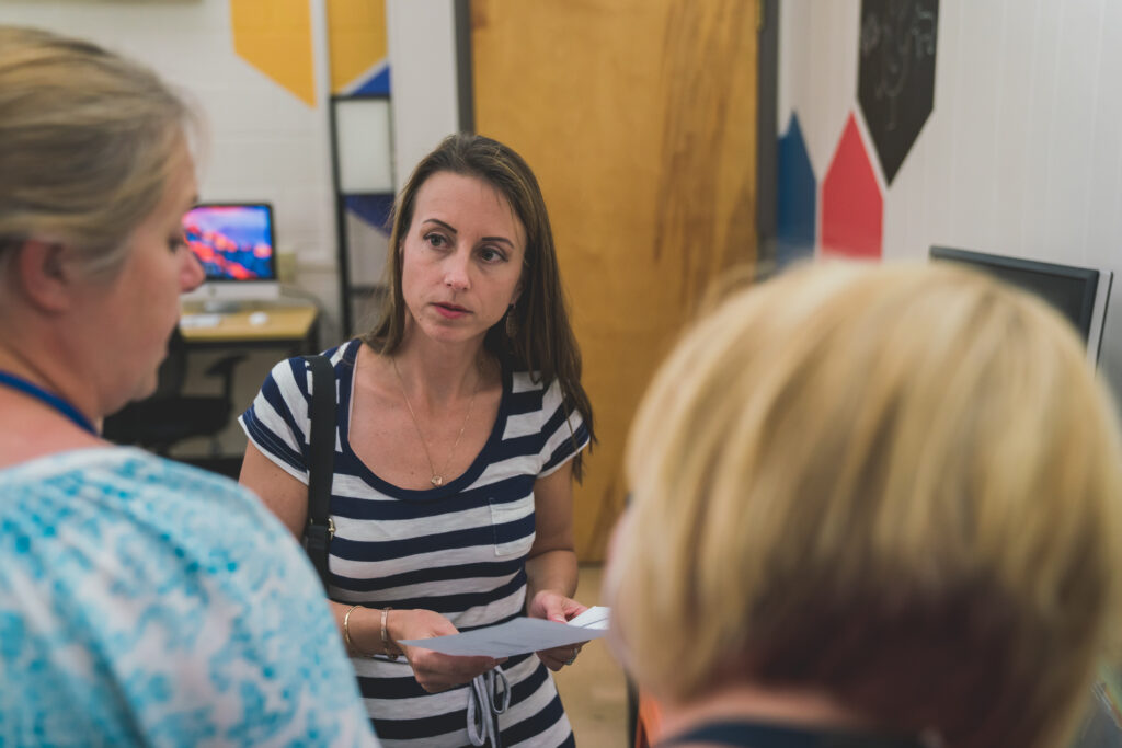 Dr. Amanda Holdsworth interviewing two employees